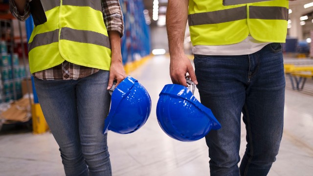 two-unrecognizable-workers-reflective-suit-walking